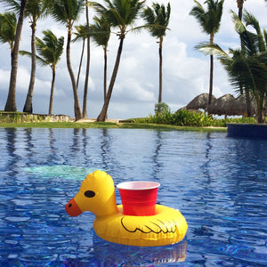 a yellow rubber duck floating in a pool
