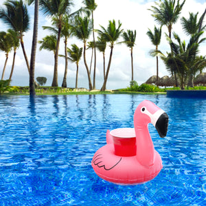 a pink flaming in a pool with palm trees in the background