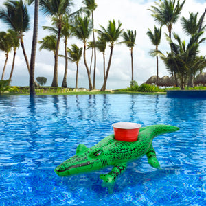 a plastic crocodile toy floating in a pool