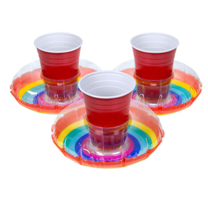 three cups on a plate with a rainbow colored design