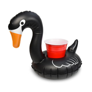 a black swan shaped inflatable with a red cup