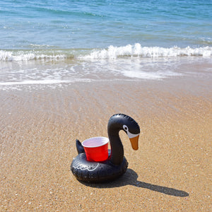 a toy duck on the beach