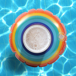a glass of milk and a rainbow - colored plate