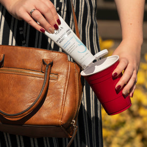 woman holding white bottle and a red cup