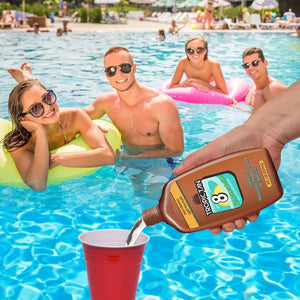 a man and woman in a pool with a bottle of suntant