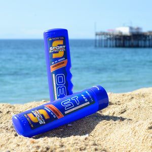 a towel, toothpas, and toothpas on the beach
