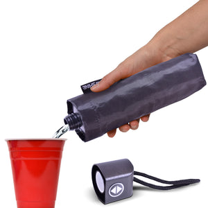 a hand holding a water bottle and a red cup